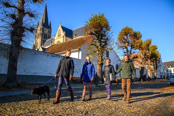 Hikers walk their dogs through Thorn town centre in autumn