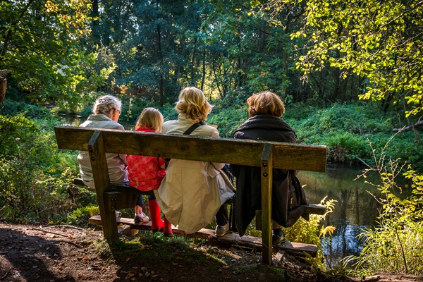 Family sits on a bench and enjoys nature in Roermond