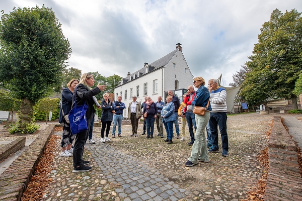 Group listens to guide talk about the history of Thorn